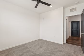 A room with a ceiling fan and carpeted floor at The Junction at Rockledge Apartments, Rockledge, FL